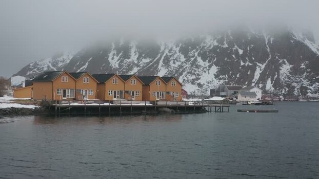 View of yellow rorbuer on the water in Ballstad Norway.