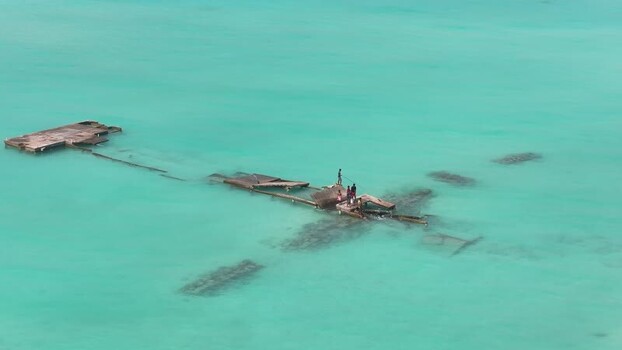 Aerial view of people on a ruined pier in turquoise water Maldives. Aerial view of people on a ruined pier in turquoise water Maldives.