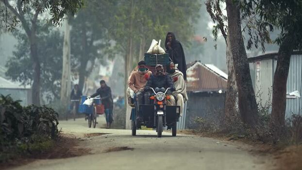 View of people on a motorized rickshaw in Bogura Bangladesh. View of people on a motorized rickshaw in Bogura Bangladesh.