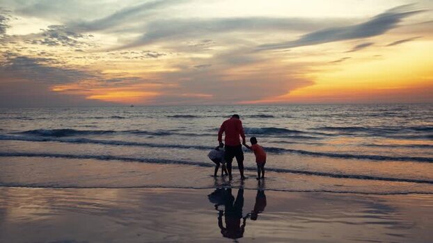 View of a family on the beach at sunset in Cox s Bazar Bangladesh.