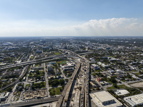 Aerial view of a sprawling cityscape with a complex network of highways buildings and the distinct form of the Kaseya Center Miami Florida USA. Aerial view of a sprawling cityscape with a complex network of highways buildings and the distinct form of the Kaseya Center Miami Florida USA.