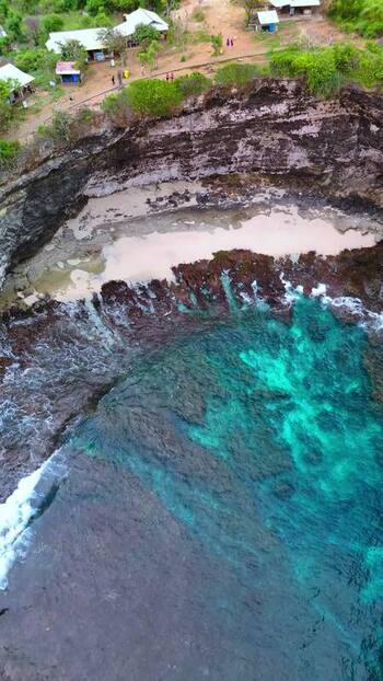 Aerial view of Broken Beach with turquoise water and cliffs Indonesia.
