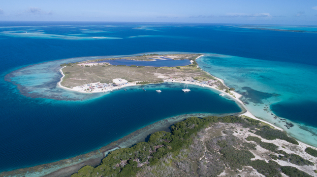 Aerial view of Los Roques archipelago featuring turquoise waters coral reefs and sandy islands in Los Roques Dependencias Federale Venezuela. Aerial view of Los Roques archipelago featuring turquoise waters coral reefs and sandy islands in Los Roques Dependencias Federale Venezuela.