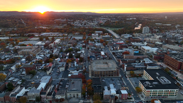 Aerial view of Reading during a vibrant autumn sunset featuring urban architecture tree lined streets with fall foliage and a bridge Reading Pennsylvania United States. Aerial view of Reading during a vibrant autumn sunset featuring urban architecture tree lined streets with fall foliage and a bridge Reading Pennsylvania United States.