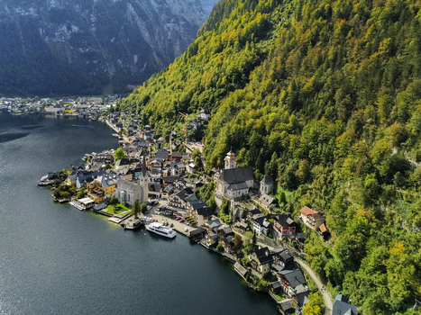 Aerial view of Hallstatt a historic lakeside village with traditional alpine architecture and the iconic Evangelical Church nestled between mountains in Hallstatt Upper Austria Austria.