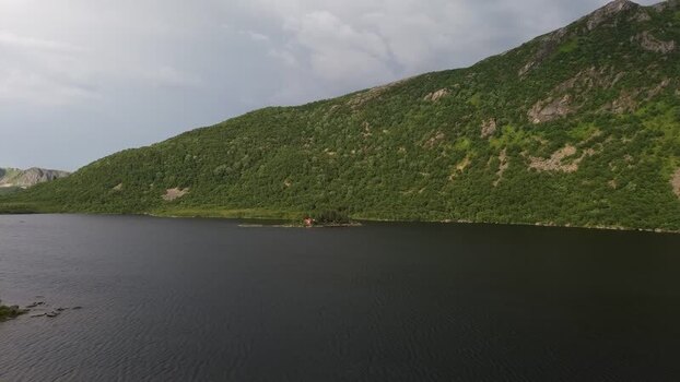 Aerial view of red cabin on island in Senja Norway.