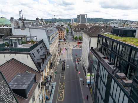 Aerial view of the urban landscape featuring historic rooftops modern buildings and a city street with pedestrians in Biel Bienne Canton of Bern Switzerland. Aerial view of the urban landscape featuring historic rooftops modern buildings and a city street with pedestrians in Biel Bienne Canton of Bern Switzerland.
