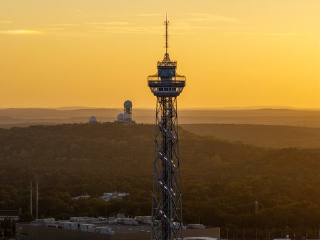 Aerial view of Funkturm Berlin with the Teufelsberg radar station in the background during golden hour in Berlin Berlin Germany.