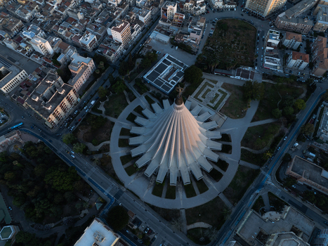 Aerial view of the modern conical architecture of the Basilica Santuario della Madonna delle Lacrime and surrounding urban landscape in Syracuse Sicily Italy. Aerial view of the modern conical architecture of the Basilica Santuario della Madonna delle Lacrime and surrounding urban landscape in Syracuse Sicily Italy.