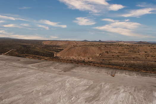 Aerial view of Pima Mine featuring large tailings piles open pit mining operations with heavy machinery and vast desert terrain in Pima County Arizona United States. Aerial view of Pima Mine featuring large tailings piles open pit mining operations with heavy machinery and vast desert terrain in Pima County Arizona United States.