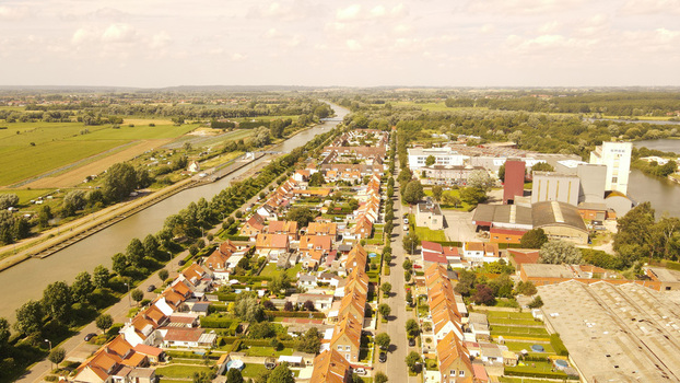 Aerial view of residential houses a canal and industrial buildings in the town of Saint Omer Hauts de France France. Aerial view of residential houses a canal and industrial buildings in the town of Saint Omer Hauts de France France.