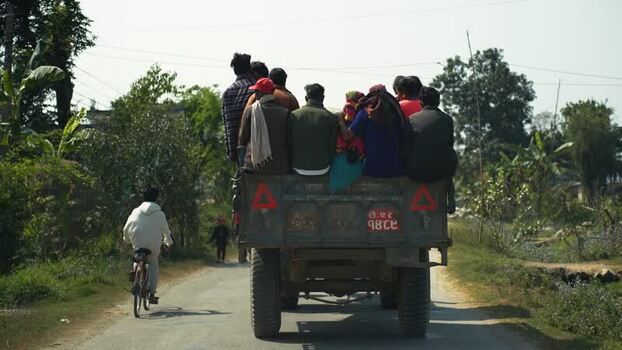 View of people riding in a tractor trailer in Dhangadhi Nepal. View of people riding in a tractor trailer in Dhangadhi Nepal.