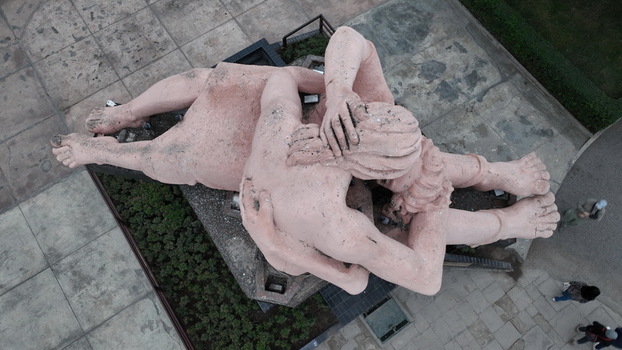 Aerial view of the iconic El Beso sculpture at Parque del Amor surrounded by paved walkways and greenery in Miraflores Provincia de Lima Peru.