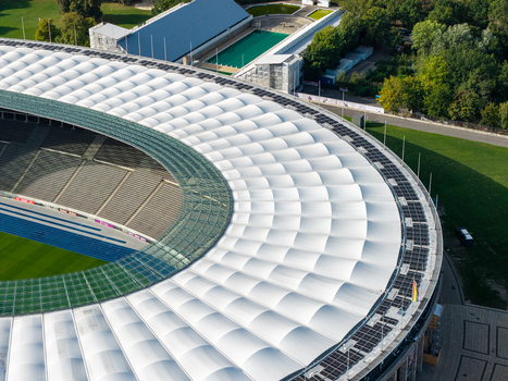 Berlin Germany 26 September 2026 Aerial view of Olympiastadion Berlin featuring its iconic white membrane roof blue running track and surrounding green parkland.