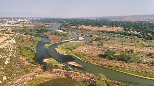 Aerial view of the Colorado River showing low water levels and smokey haze during a severe drought near Grand Junction Colorado United States. Aerial view of the Colorado River showing low water levels and smokey haze during a severe drought near Grand Junction Colorado United States.
