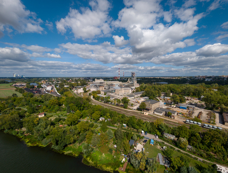 Opole Poland 06 September 2026 Aerial view of Cement Odra SA industrial plant along the Oder river featuring factory buildings tall chimneys and green landscape under a blue sky. Opole Poland 06 September 2026 Aerial view of Cement Odra SA industrial plant along the Oder river featuring factory buildings tall chimneys and green landscape under a blue sky.