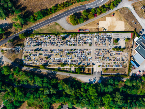 Aerial view of the cemetery in Neuf Brisach with organized rows of graves surrounding lush green trees and adjacent roads Neuf Brisach Grand Est France.