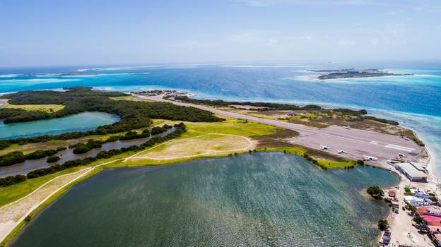 Aerial view of Los Roques archipelago featuring the airstrip turquoise waters and lush mangrove vegetation in Los Roques Dependencias Federale Venezuela. Aerial view of Los Roques archipelago featuring the airstrip turquoise waters and lush mangrove vegetation in Los Roques Dependencias Federale Venezuela.