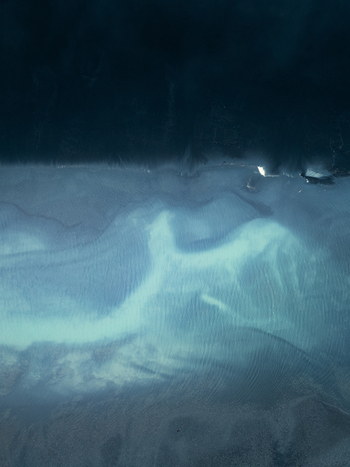 Aerial view of the dramatic Icelandic coastline with dark deep waters meeting turquoise shallows and volcanic sand Iceland. Aerial view of the dramatic Icelandic coastline with dark deep waters meeting turquoise shallows and volcanic sand Iceland.