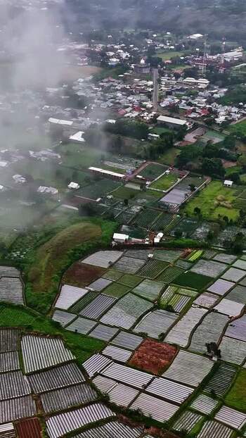 Aerial view of agricultural fields and rural village in Bali Indonesia.