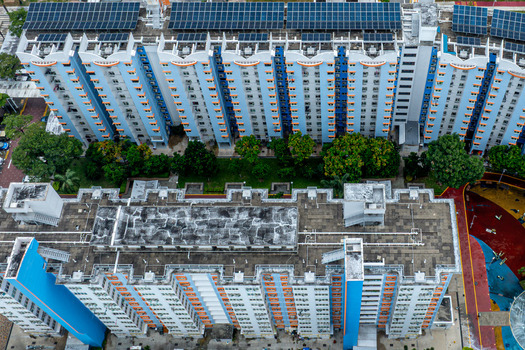 Aerial view of Boon Keng public housing blocks with solar panels on the rooftops lush green trees and a colorful playground area below in Singapore Bendemeer Road Singapore. Aerial view of Boon Keng public housing blocks with solar panels on the rooftops lush green trees and a colorful playground area below in Singapore Bendemeer Road Singapore.