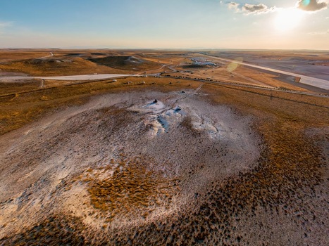 Aerial view of the arid landscape near Sivrihisar featuring rolling hills dry vegetation and a distant road under a warm sunset sky in Sivrihisar Eskisehir Turkey. Aerial view of the arid landscape near Sivrihisar featuring rolling hills dry vegetation and a distant road under a warm sunset sky in Sivrihisar Eskisehir Turkey.