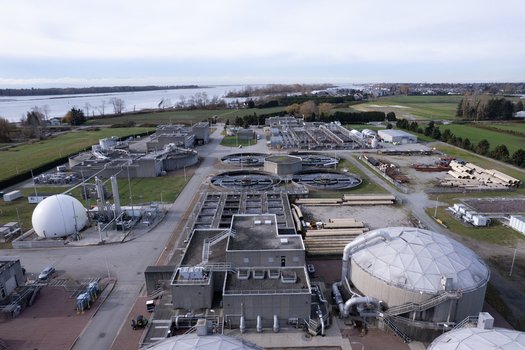 Aerial view of the Lulu Island Wastewater Treatment Plant featuring circular sedimentation tanks industrial buildings and storage domes in Richmond British Columbia Canada. Aerial view of the Lulu Island Wastewater Treatment Plant featuring circular sedimentation tanks industrial buildings and storage domes in Richmond British Columbia Canada.