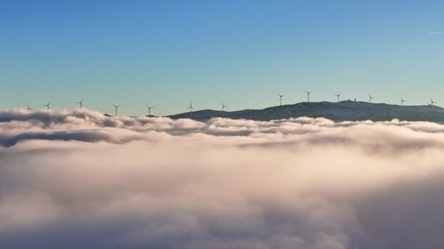 Aerial view of Windpark Freilanderalm 2 above clouds Austria.