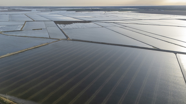 Aerial view of the flooded rice fields at Isla Minima with water reflecting the sky in a geometric grid pattern Sevilla Andalucia Spain. Aerial view of the flooded rice fields at Isla Minima with water reflecting the sky in a geometric grid pattern Sevilla Andalucia Spain.