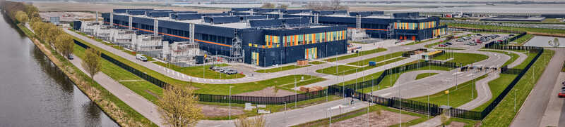 Middenmeer Netherlands 15 April 2026 Aerial view of Microsoft Datacenter Campus AMS 13 and 14 with modern dark buildings colorful facades and a canal under a clear sky. Middenmeer Netherlands 15 April 2026 Aerial view of Microsoft Datacenter Campus AMS 13 and 14 with modern dark buildings colorful facades and a canal under a clear sky.