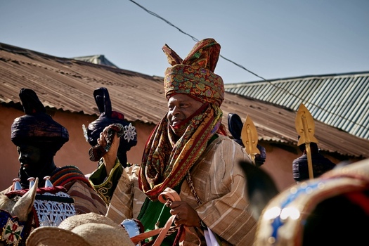 Zaria Nigeria 21 March 2026 View of a dignified figure adorned in a vibrant intricately patterned hat and flowing robes bathed in warm sunlight against a muted textured backdrop. Zaria Nigeria 21 March 2026 View of a dignified figure adorned in a vibrant intricately patterned hat and flowing robes bathed in warm sunlight against a muted textured backdrop.