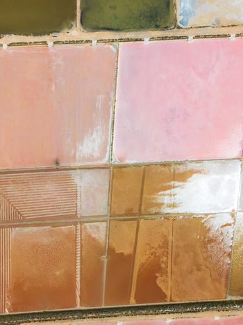 Aerial view of the colorful pink and brown salt evaporation ponds at Salines des Trenc with geometric patterns Campos Islas Baleares Spain. Aerial view of the colorful pink and brown salt evaporation ponds at Salines des Trenc with geometric patterns Campos Islas Baleares Spain.