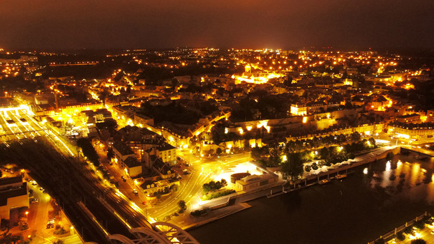 Aerial view of the illuminated cityscape of Pontoise at night with glowing streetlights historic buildings and the Oise river in Pontoise Ile de France France. Aerial view of the illuminated cityscape of Pontoise at night with glowing streetlights historic buildings and the Oise river in Pontoise Ile de France France.