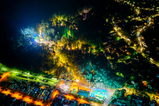 Aerial view of the Annafest festival at night with colorful lights illuminating the Kellerwald forest and surrounding streets in Forchheim Bayern Germany. Aerial view of the Annafest festival at night with colorful lights illuminating the Kellerwald forest and surrounding streets in Forchheim Bayern Germany.