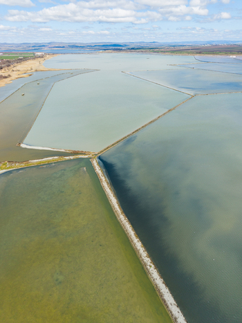 Aerial view of Lake Atanasovsko showing geometric salt pans divided by narrow dikes under a cloudy sky in Burgas Burgas Bulgaria. Aerial view of Lake Atanasovsko showing geometric salt pans divided by narrow dikes under a cloudy sky in Burgas Burgas Bulgaria.
