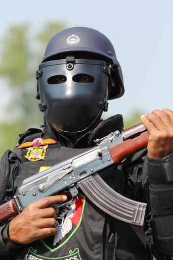 Dhaka Bangladesh 08 January 2017 View of a member of the Rapid Action Battalion RAB in full tactical gear including a helmet with a face shield holding an assault rifle. Dhaka Bangladesh 08 January 2017 View of a member of the Rapid Action Battalion RAB in full tactical gear including a helmet with a face shield holding an assault rifle.