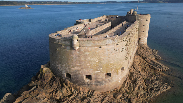 Aerial view of the imposing Ch&acirc;teau du Taureau a stone fortress surrounded by the sea stands resilient against the crashing waves Plouezoc h Bretagne France.