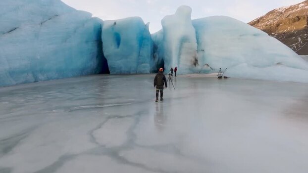 Aerial view of a blue glacier with people in Iceland. Aerial view of a blue glacier with people in Iceland.
