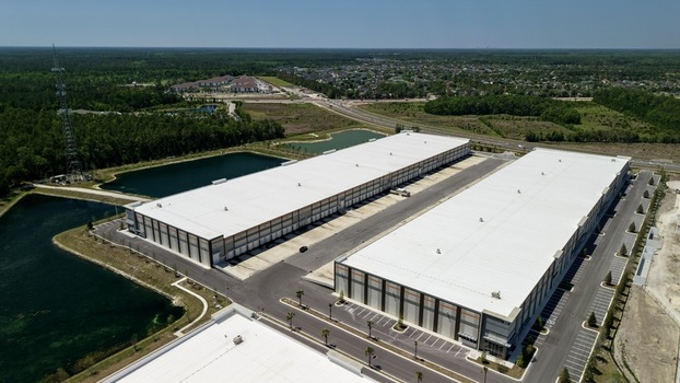 Aerial view of large modern industrial warehouses with white roofs near Saint Johns Parkway and International Golf Parkway in World Golf Village Florida United States. Aerial view of large modern industrial warehouses with white roofs near Saint Johns Parkway and International Golf Parkway in World Golf Village Florida United States.