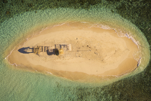 Aerial view of a small isolated wooden hut on the little island of Cayo Arena in Guayubin state Dominican Republic.