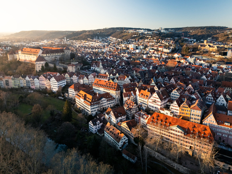 Aerial view of Hohentubingen Castle and the historic old town with colorful half timbered houses along the Neckar river at sunset in Tubingen Baden Wurttemberg Germany.