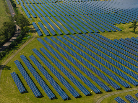 Aerial view of Lisburn Solar Farm with rows of photovoltaic panels arranged in a green field in Lisburn Northern Ireland United Kingdom. Aerial view of Lisburn Solar Farm with rows of photovoltaic panels arranged in a green field in Lisburn Northern Ireland United Kingdom.