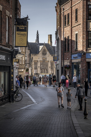 Durham England United Kingdom 13 July 2026 View of a street in Durham with historic brick buildings pedestrians on the cobblestone path and a sign for Saddlers Yard. Durham England United Kingdom 13 July 2026 View of a street in Durham with historic brick buildings pedestrians on the cobblestone path and a sign for Saddlers Yard.