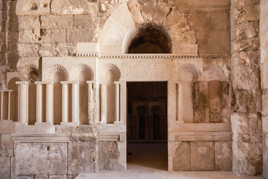 View of the historic stone archway and intricate architectural details of the Umayyad Palace in Amman Amman Governorate Jordan.
