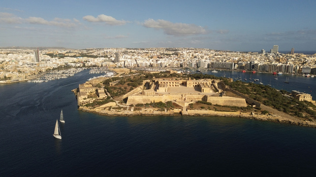 Aerial view of Fort Manoel on Manoel Island surrounded by the blue waters of Marsamxett Harbour with the Valletta skyline and yachts in Valletta Port Region Malta. Aerial view of Fort Manoel on Manoel Island surrounded by the blue waters of Marsamxett Harbour with the Valletta skyline and yachts in Valletta Port Region Malta.