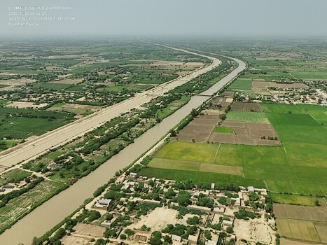 Aerial view of the Kichi Canal running parallel to the DG Canal through the agricultural landscape of Dera Ghazi Khan Punjab Pakistan.
