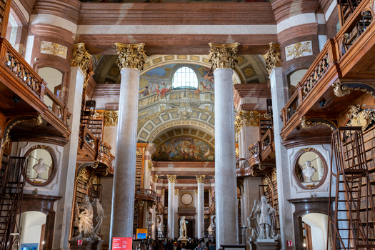 Wien Austria 26 April 2026 View of the Austrian National Library featuring grand marble columns ornate wooden bookshelves and a frescoed dome in the State Hall. Wien Austria 26 April 2026 View of the Austrian National Library featuring grand marble columns ornate wooden bookshelves and a frescoed dome in the State Hall.