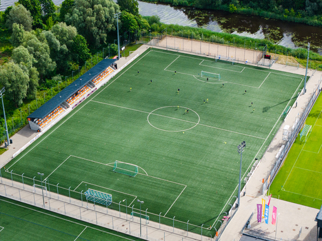 Riga Latvia 05 July 2026 Aerial view of LNK Sporta Parks with soccer players on the pitch grandstand and surrounding greenery. Riga Latvia 05 July 2026 Aerial view of LNK Sporta Parks with soccer players on the pitch grandstand and surrounding greenery.