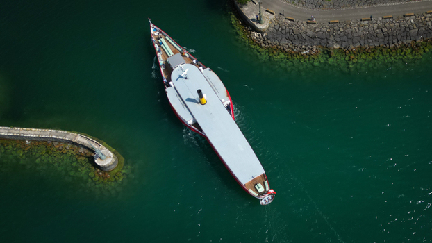 Aerial view of a ship sailing through the water near stone jetties its red and white contrasting against the deep green water Neuchâtel Neuchâtel Switzerland. Aerial view of a ship sailing through the water near stone jetties its red and white contrasting against the deep green water Neuchâtel Neuchâtel Switzerland.