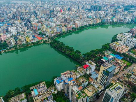Dhaka Bangladesh 19 June 2026 Aerial view of Gulshan Lake surrounded by dense urban development high rise buildings and lush green trees in the city.